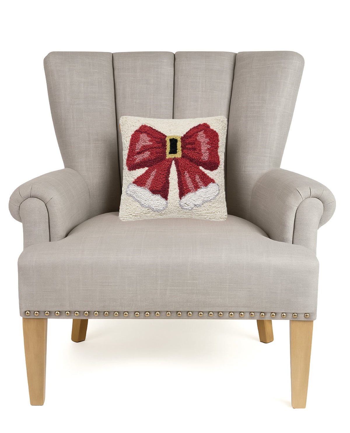 Santa Hat Bow Hooked Wool Christmas Throw Pillow on an armchair, showing the throw pillow at room scale, 10x10 inch