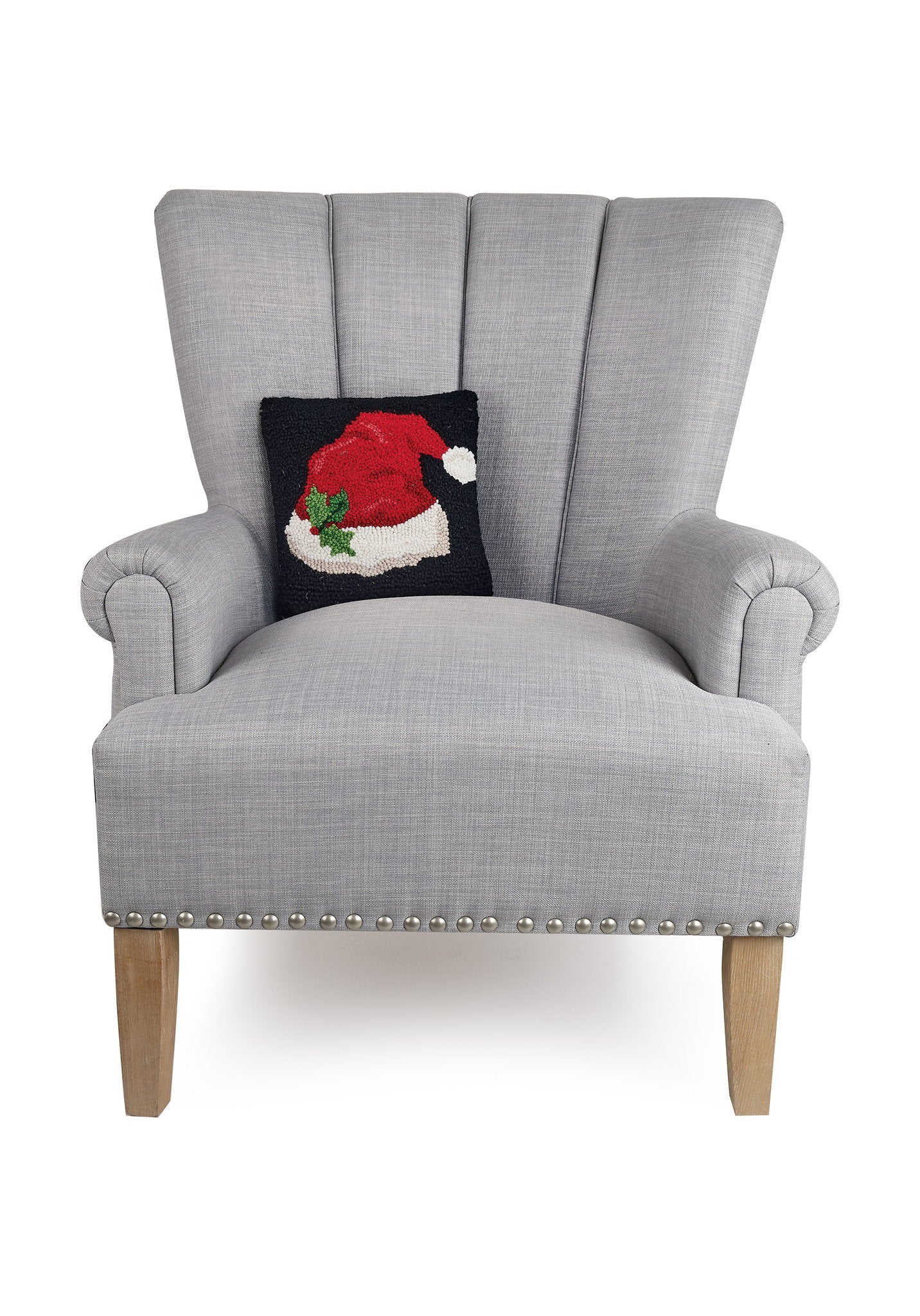 Santa Hat Hooked Wool Christmas Throw Pillow on an armchair, showing the throw pillow at room scale, 10x10 inch