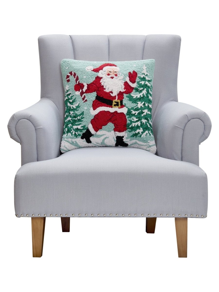 Santa with Candy Cane Hooked Wool Christmas Throw Pillow on an armchair, showing the throw pillow at room scale, 18x18 inch