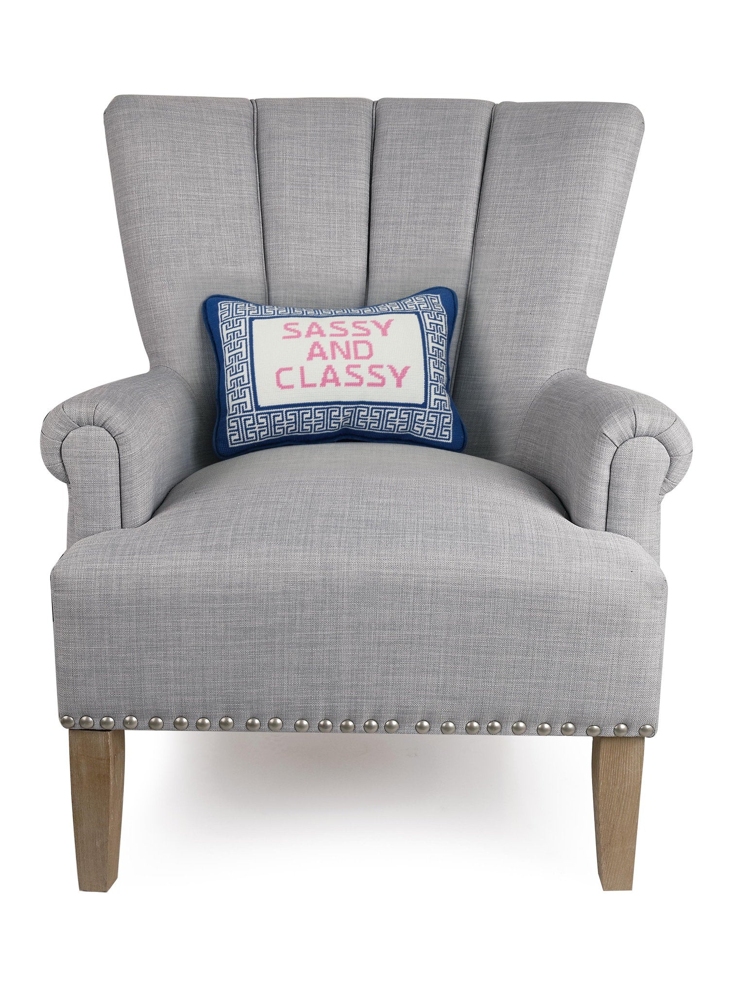 Sassy/Classy Embroidered Needlepoint Throw Pillow on an armchair, showing the throw pillow at room scale, 10x14 inch