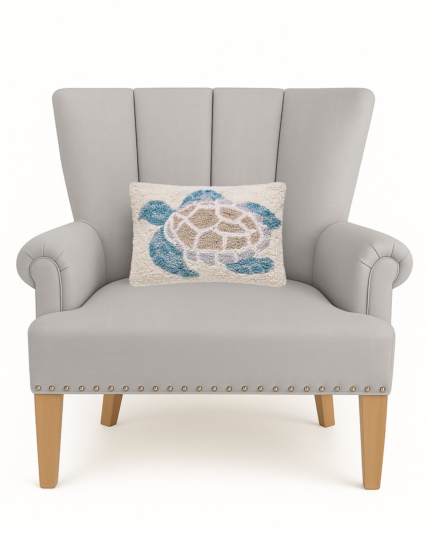 Sea Turtle Hooked Wool Throw Pillow on an armchair, showing the throw pillow at room scale, 8x12 inch