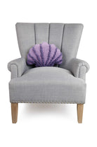 Seashell Shaped Hooked Wool Throw Pillow on an armchair, showing the throw pillow at room scale, 12x16 inch