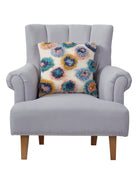 Shaggy Pom Poms Embroidered Throw Pillow on an armchair, showing the throw pillow at room scale, 18x18 inch