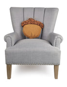 Shaped Acorn Hooked Wool Fall Harvest Throw Pillow on an armchair, showing the throw pillow at room scale, 14x14 inch