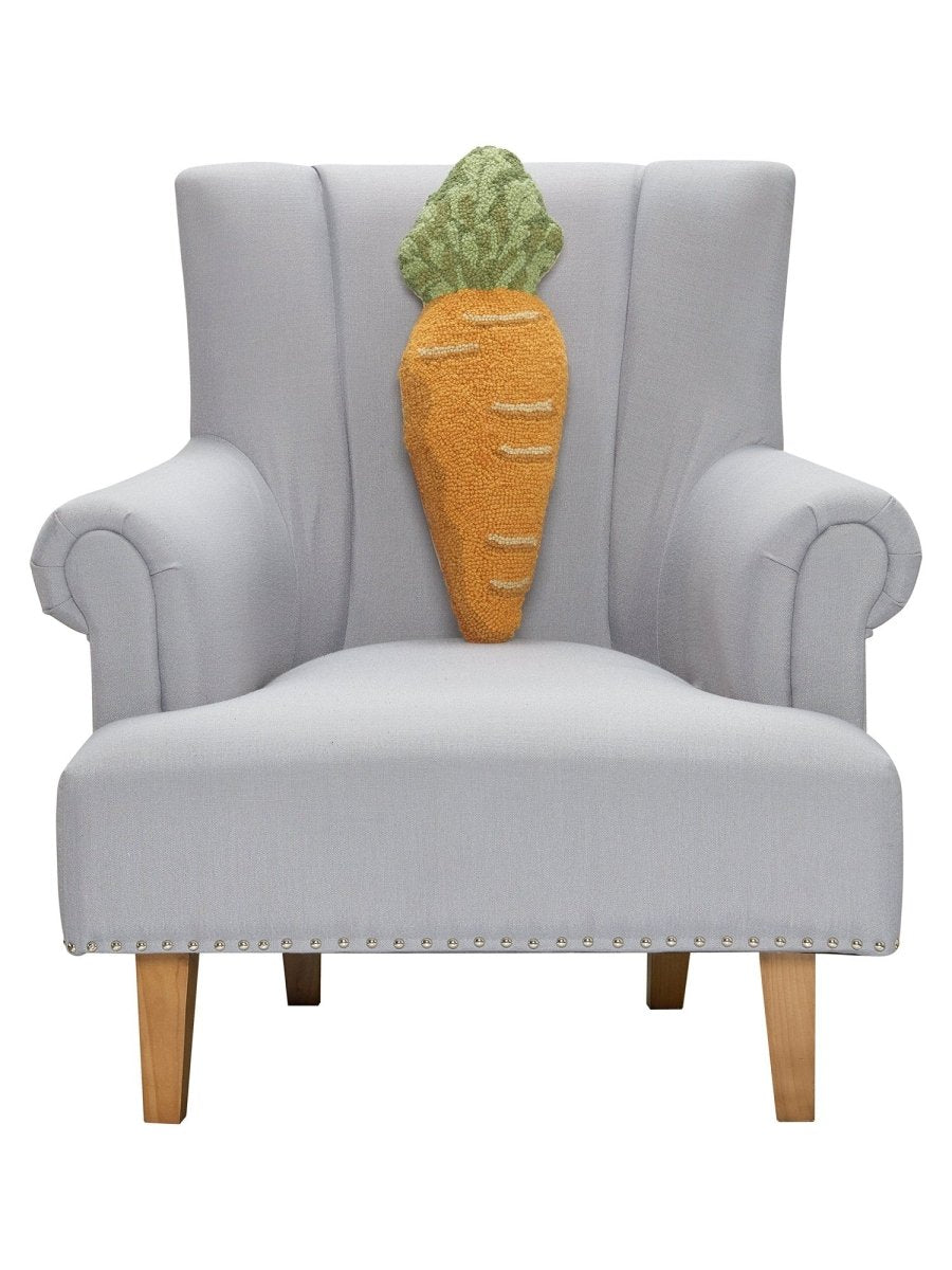 Shaped Carrot Hooked Wool Easter Throw Pillow on an armchair, showing the throw pillow at room scale, 8x22 inch