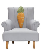 Shaped Carrot Hooked Wool Easter Throw Pillow on an armchair, showing the throw pillow at room scale, 8x22 inch