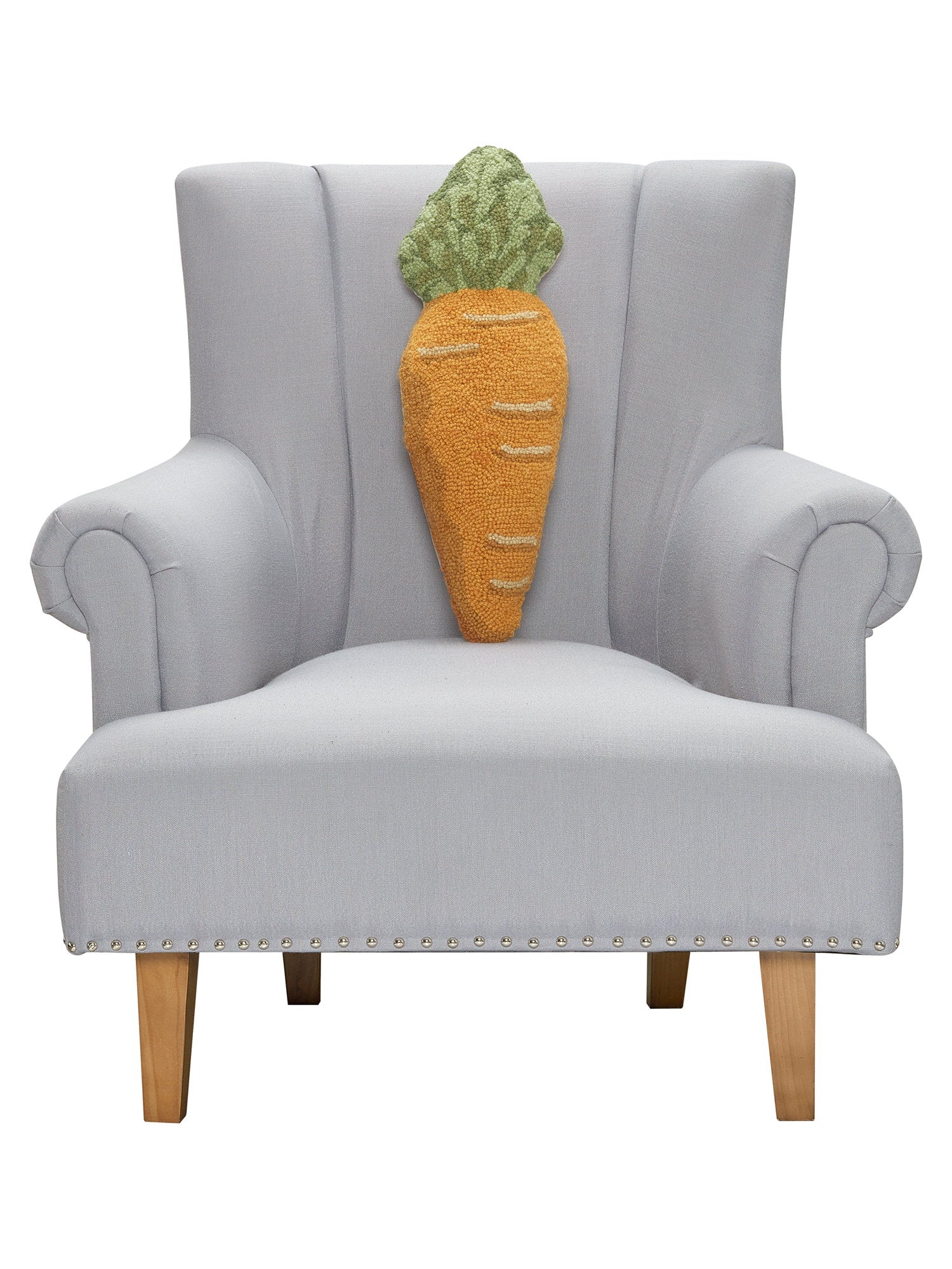 Shaped Carrot Hooked Wool Easter Throw Pillow on an armchair, showing the throw pillow at room scale, 8x22 inch