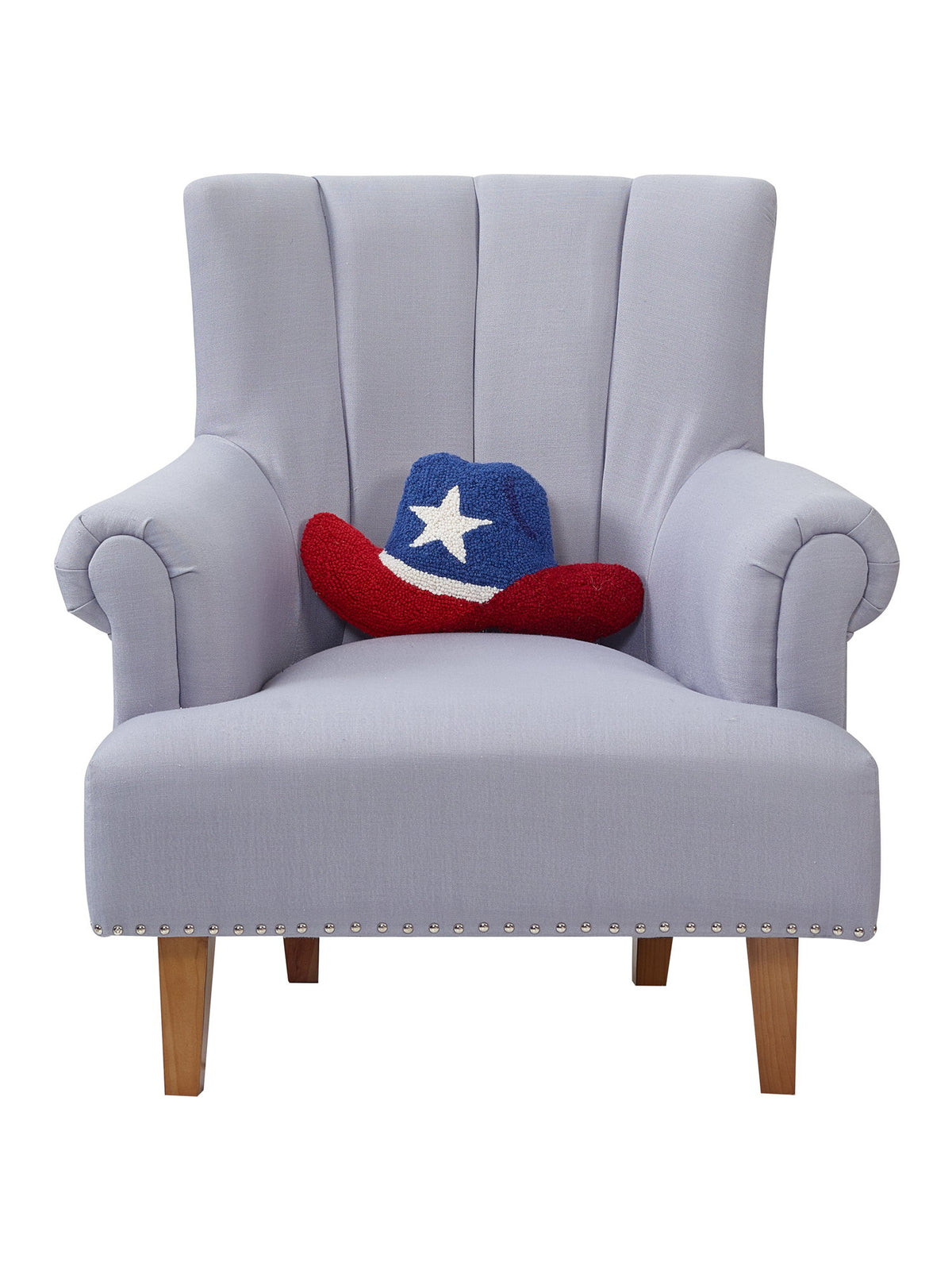 Shaped Cowboy Patriotic Hat Hooked Wool Throw Pillow on an armchair, showing the throw pillow at room scale, 9x16 inch