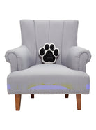 Shaped Dog Paw Hooked Wool Throw Pillow on an armchair, showing the throw pillow at room scale, 10x10 inch