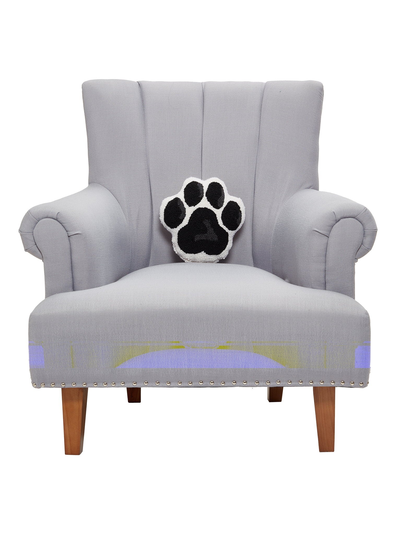 Shaped Dog Paw Hooked Wool Throw Pillow on an armchair, showing the throw pillow at room scale, 10x10 inch