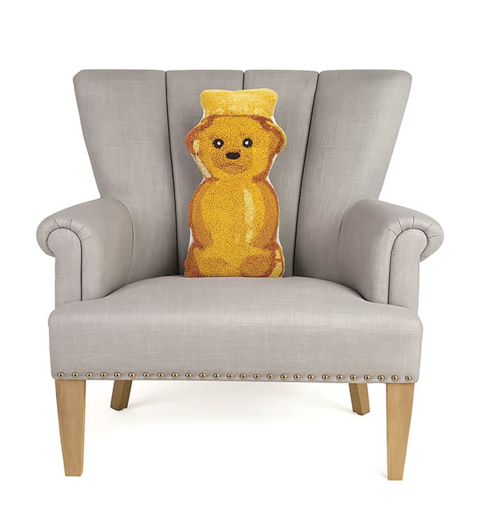 Shaped Honey Bear Hooked Wool Throw Pillow on an armchair, showing the throw pillow at room scale, 9x16 inch