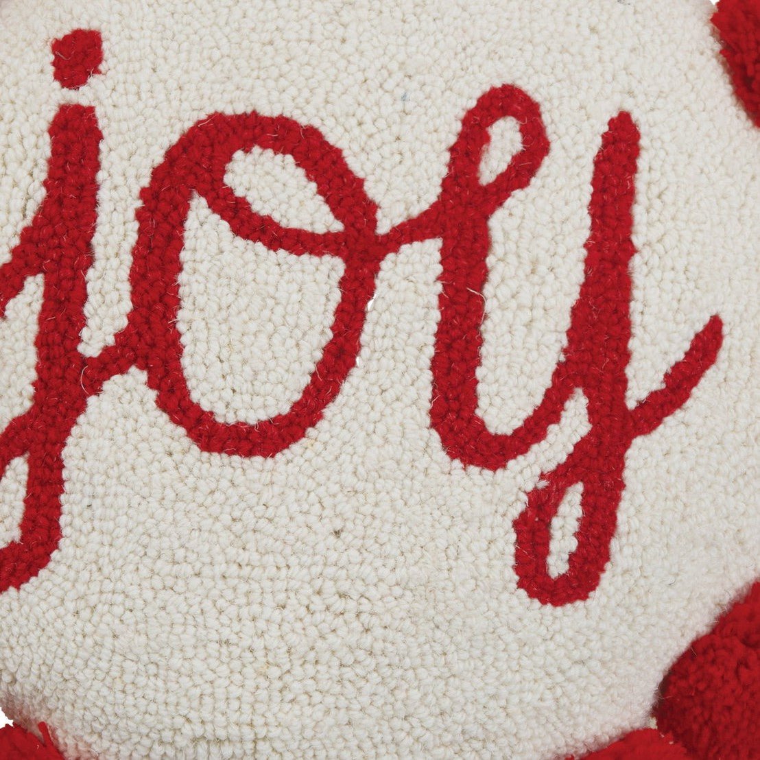 Closeup of Shaped Joy with Pom Pom Hooked Wool Christmas Throw Pillow showing stitch texture and craftsmanship detail