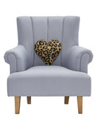 Shaped Leopard Heart Hooked Wool Throw Pillow on an armchair, showing the throw pillow at room scale, 12x12 inch