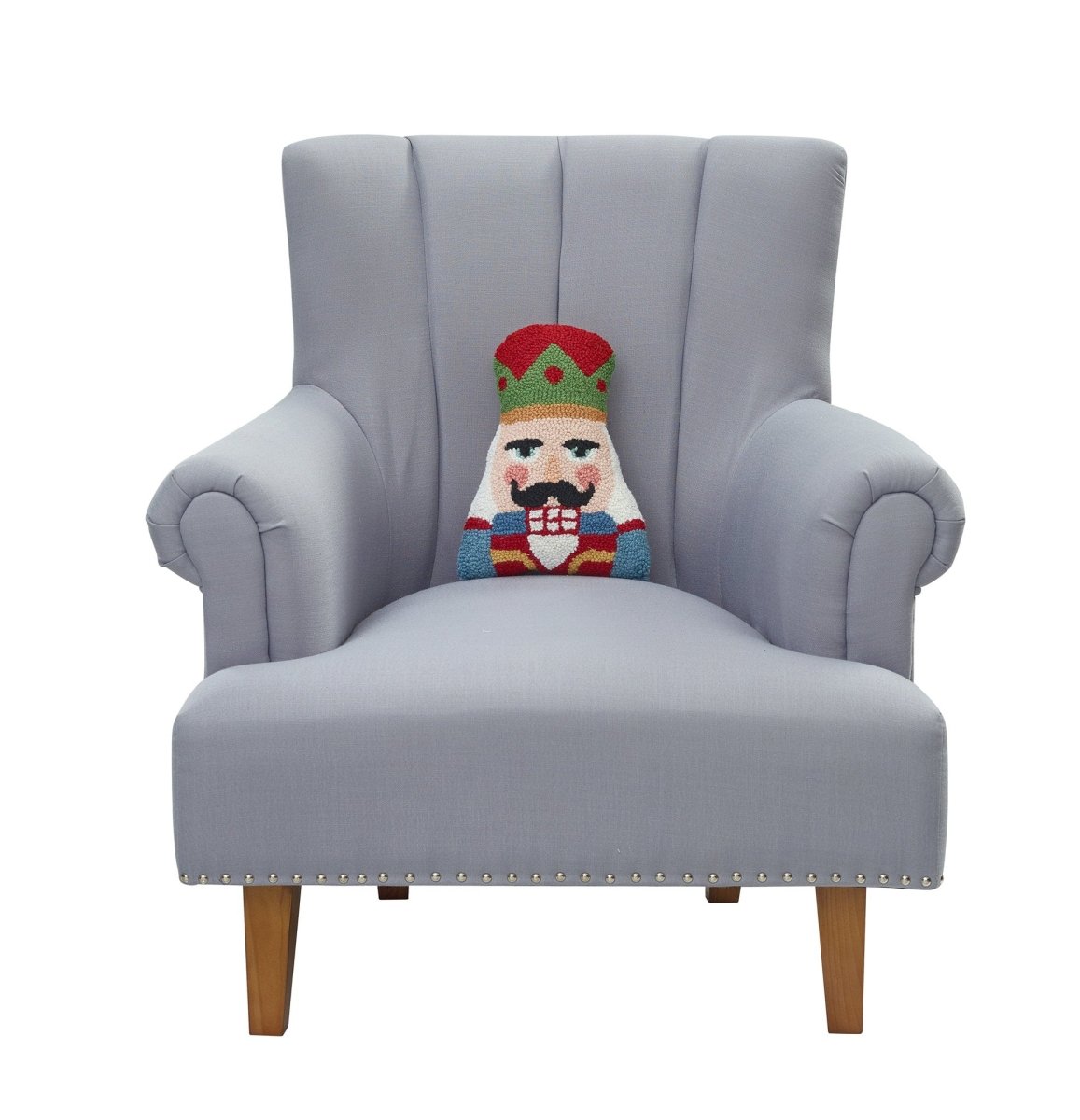 Shaped Nutcracker Hooked Wool Christmas Throw Pillow on an armchair, showing the throw pillow at room scale, 8x12 inch