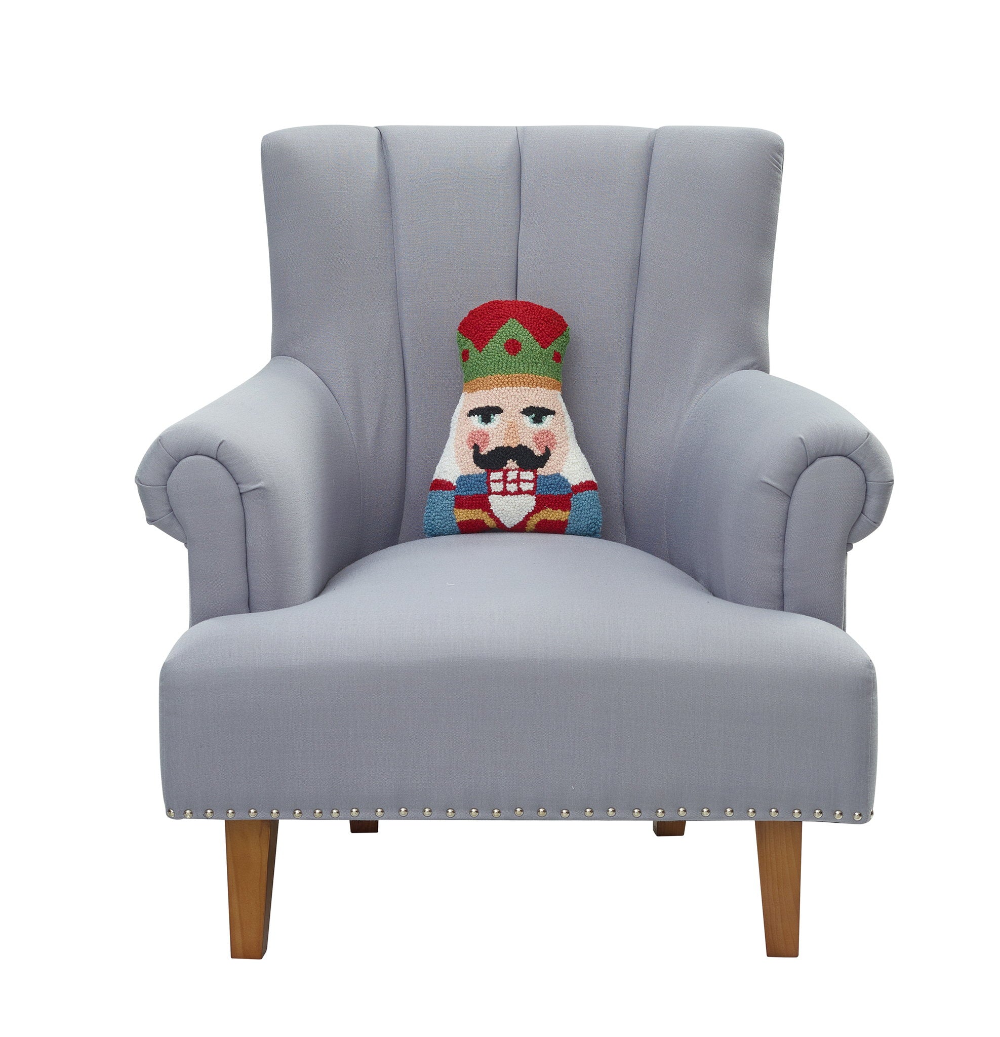 Shaped Nutcracker Hooked Wool Christmas Throw Pillow on an armchair, showing the throw pillow at room scale, 8x12 inch