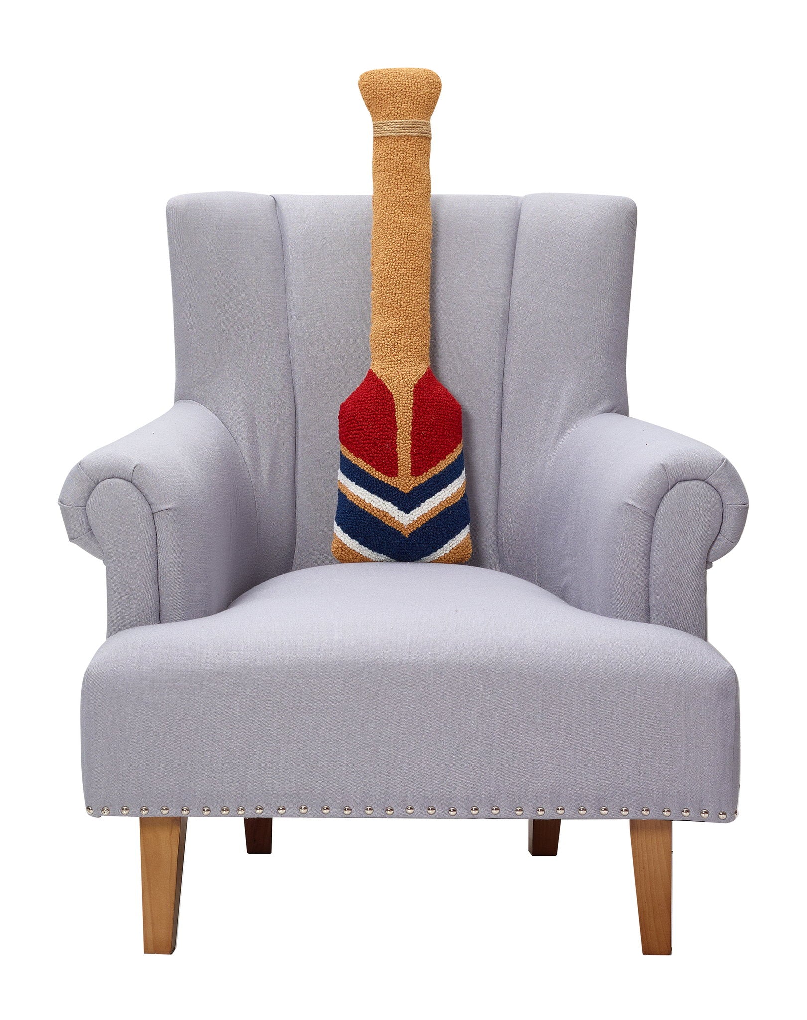 Shaped Oar Hooked Wool Throw Pillow on an armchair, showing the throw pillow at room scale, 8x30 inch