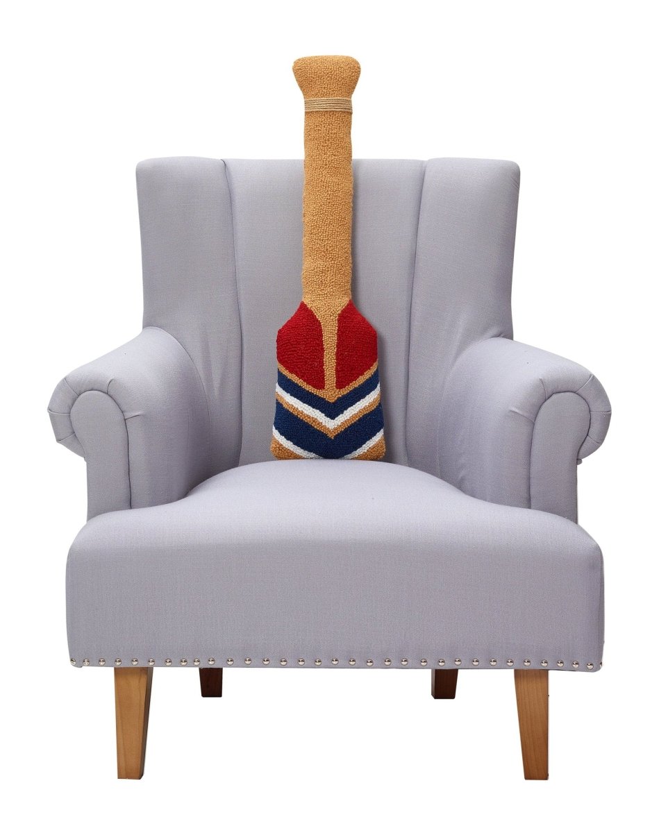Shaped Oar Hooked Wool Throw Pillow on an armchair, showing the throw pillow at room scale, 8x30 inch