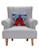Shaped Patriotic Bow Hooked Wool Throw Pillow on an armchair, showing the throw pillow at room scale, 16x16 inch