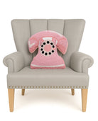Shaped Pink Telephone Hooked Wool Throw Pillow on an armchair, showing the throw pillow at room scale, 14x16 inch