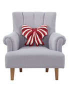 Shaped Red & White Bow Hooked Wool Christmas Throw Pillow on an armchair, showing the throw pillow at room scale, 16x16 inch