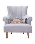 Shaped Salmon Hooked Wool Throw Pillow on an armchair, showing the throw pillow at room scale, 8x22 inch