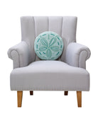 Shaped Sand Dollar Hooked Wool Throw Pillow on an armchair, showing the throw pillow at room scale, 14x14 inch