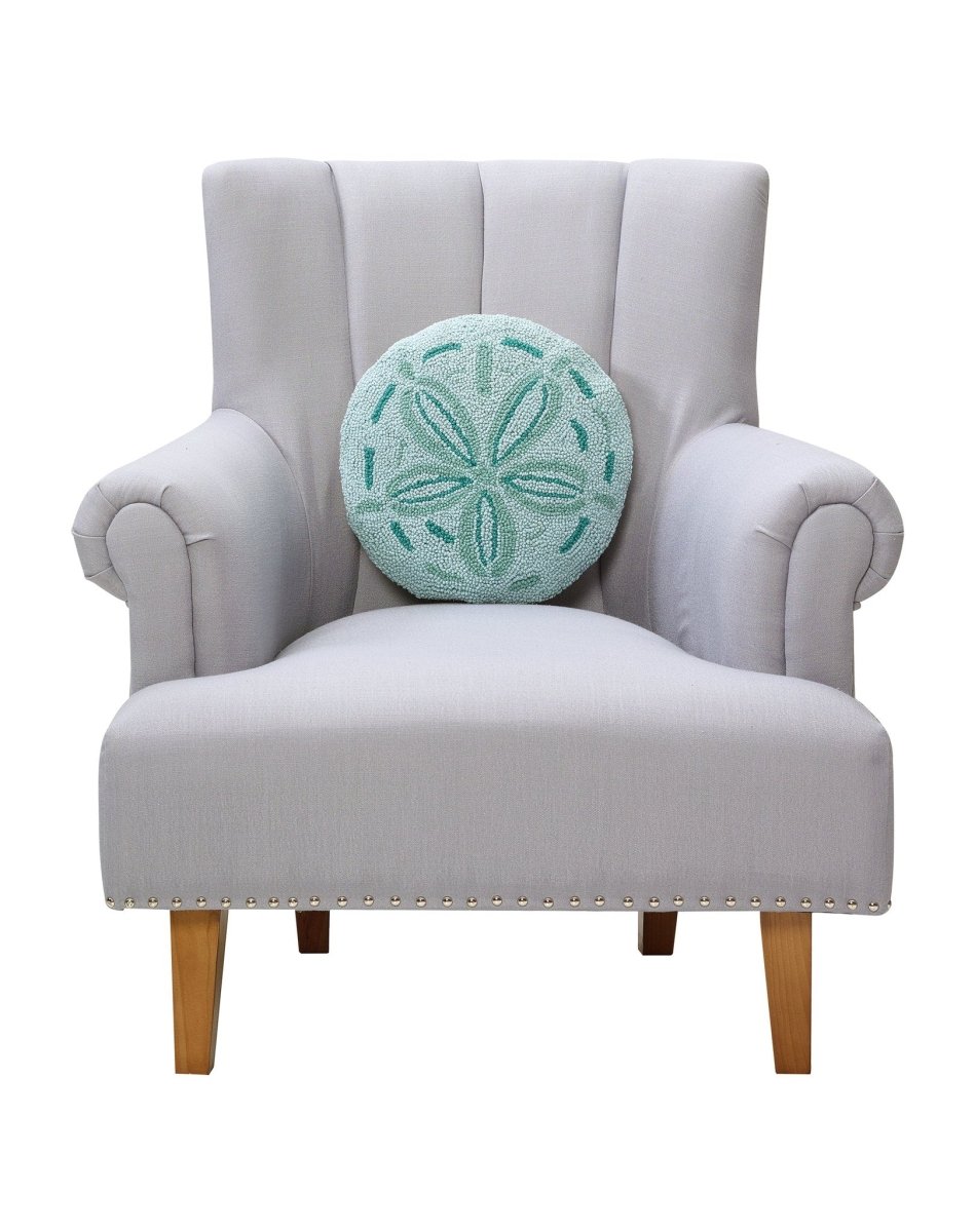 Shaped Sand Dollar Hooked Wool Throw Pillow on an armchair, showing the throw pillow at room scale, 14x14 inch