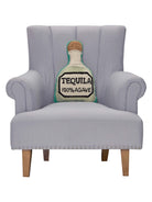 Shaped Tequila Hooked Wool Throw Pillow on an armchair, showing the throw pillow at room scale, 12x18 inch