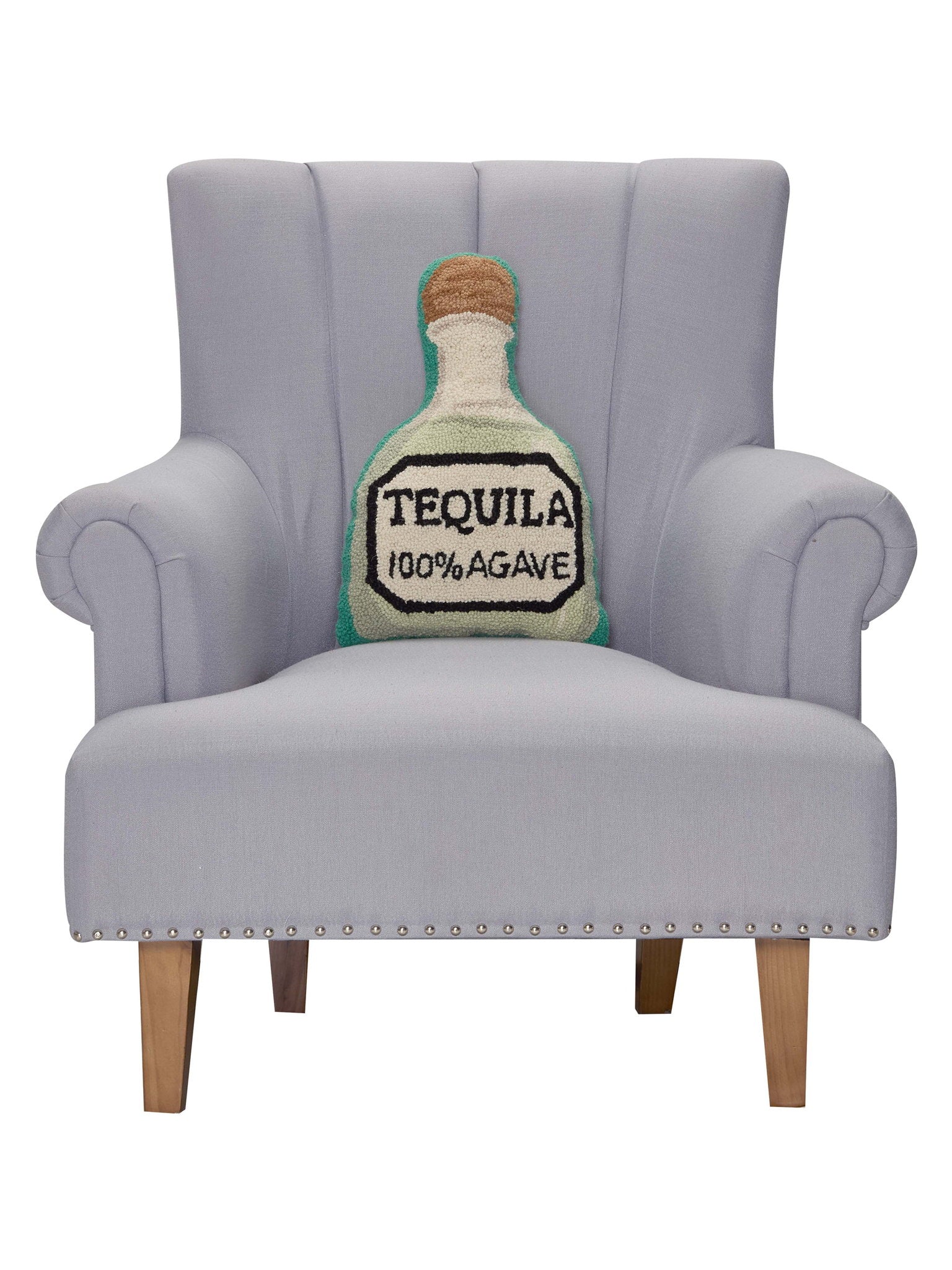 Shaped Tequila Hooked Wool Throw Pillow on an armchair, showing the throw pillow at room scale, 12x18 inch