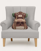 Shaped Trekking Hooked Wool Throw Pillow on an armchair, showing the throw pillow at room scale, 14x18 inch