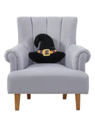Shaped Witch Hat Hooked Wool Halloween Throw Pillow on an armchair, showing the throw pillow at room scale, 14x16 inch