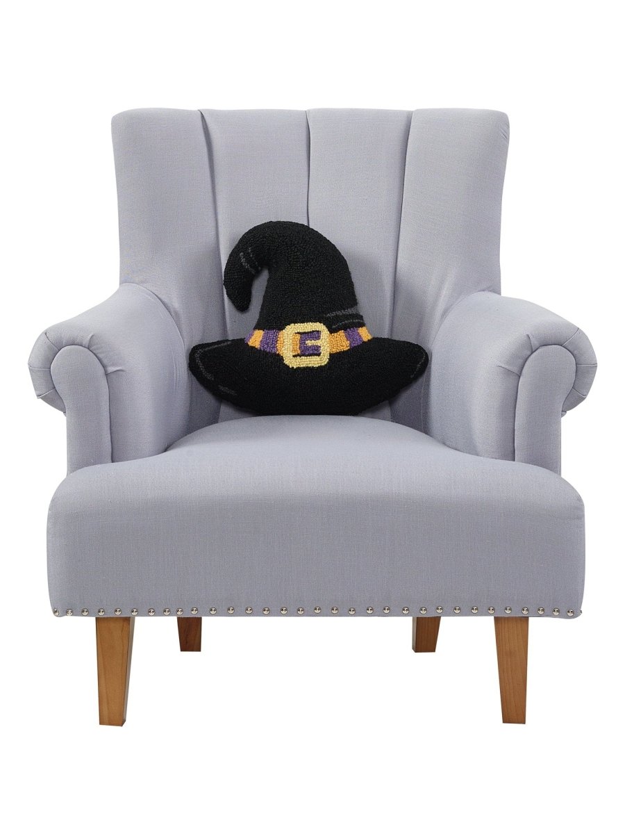 Shaped Witch Hat Hooked Wool Halloween Throw Pillow on an armchair, showing the throw pillow at room scale, 14x16 inch