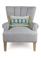 Shelby Decorative Woven Throw Pillow on an armchair, showing the throw pillow at room scale, 12x18 inch