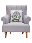 Single Blue Bloom Mughal Flower Hooked Wool Throw Pillow on an armchair, showing the throw pillow at room scale, 16x16 inch