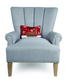Sitting Reindeer Hooked Wool Christmas Throw Pillow on an armchair, showing the throw pillow at room scale, 8x12 inch
