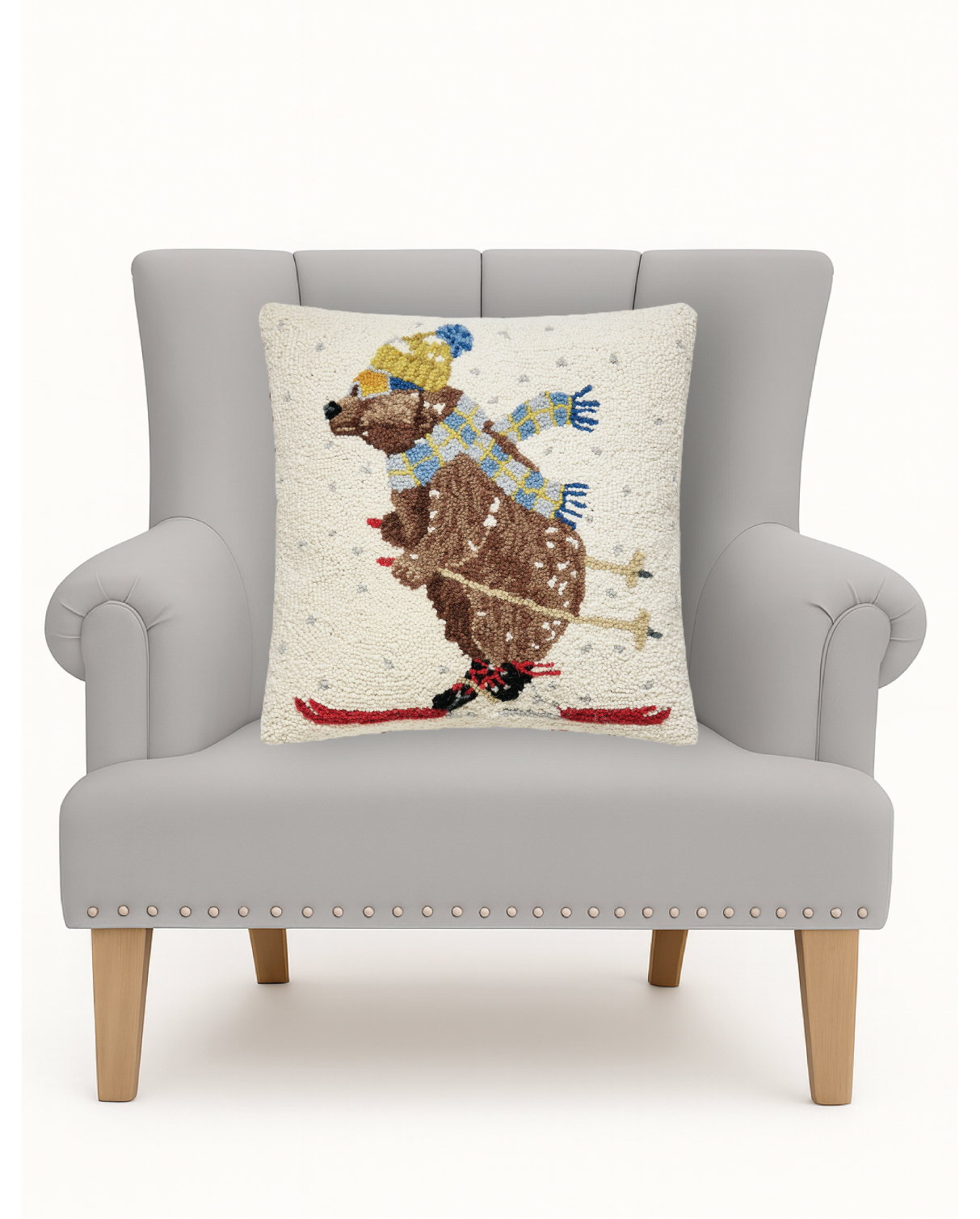 Ski Bear Hooked Wool Christmas Throw Pillow on an armchair, showing the throw pillow at room scale, 18x18 inch