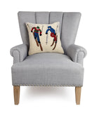 Ski Buddies Hooked Wool Christmas Throw Pillow on an armchair, showing the throw pillow at room scale, 16x16 inch