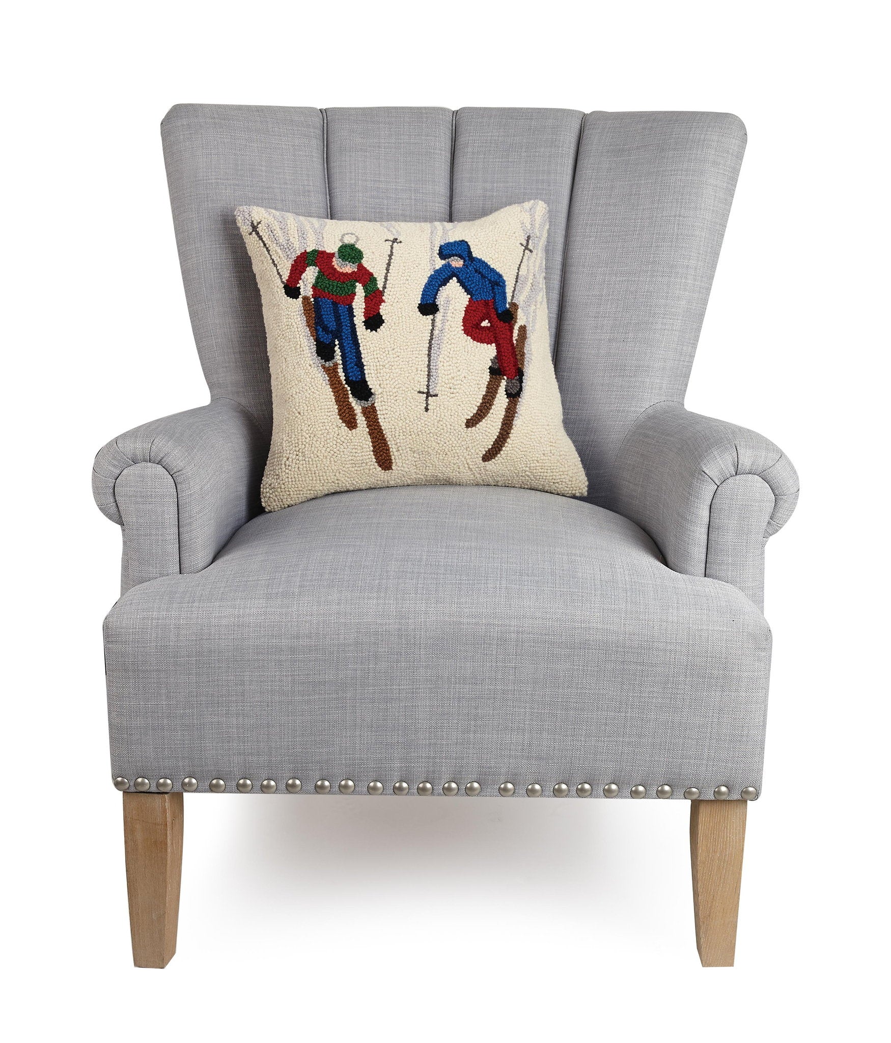 Ski Buddies Hooked Wool Christmas Throw Pillow on an armchair, showing the throw pillow at room scale, 16x16 inch