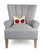 Smiling Face Cherries Hooked Wool Throw Pillow on an armchair, showing the throw pillow at room scale, 8x12 inch