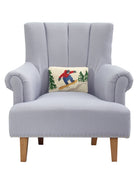Snowboarder Hooked Wool Christmas Throw Pillow on an armchair, showing the throw pillow at room scale, 8x12 inch
