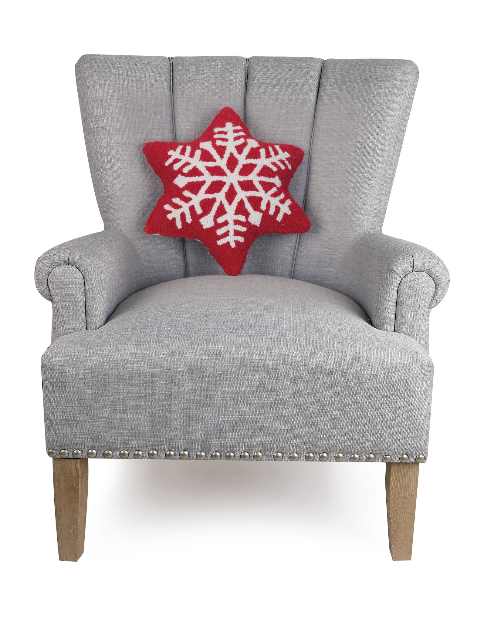 Snowflake Shaped Hooked Wool Christmas Throw Pillow on an armchair, showing the throw pillow at room scale, 14x16 inch