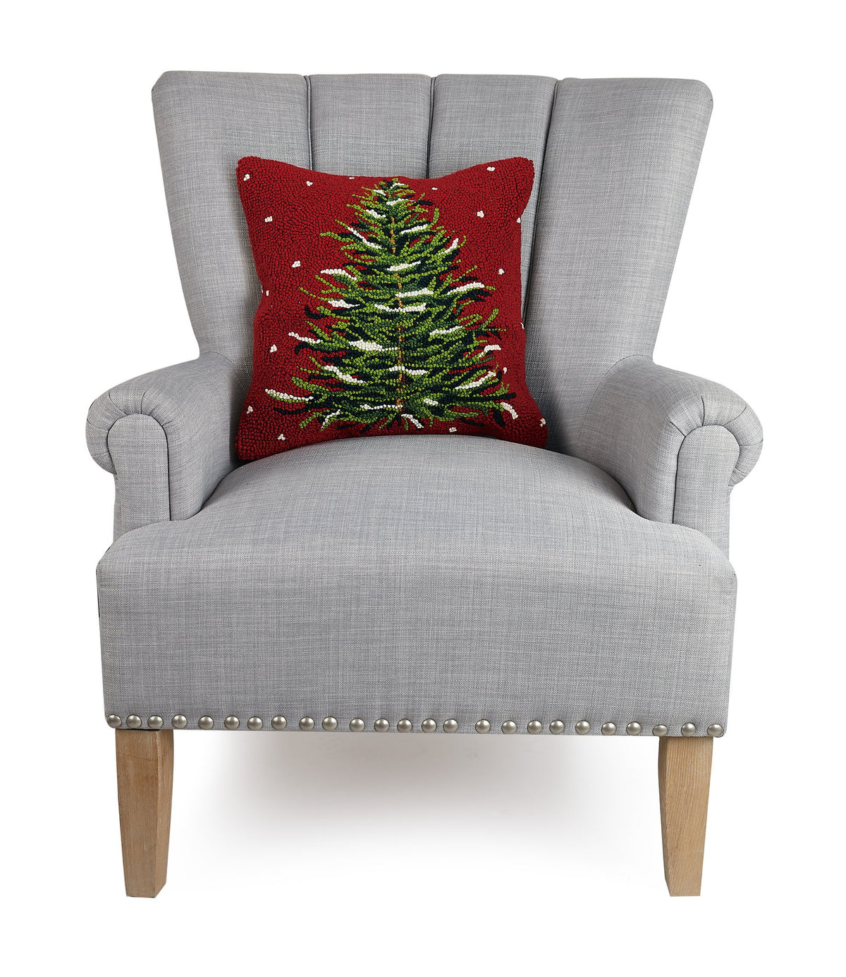 Snowy Evergreen Christmas Tree Hooked Wool Throw Pillow on an armchair, showing the throw pillow at room scale, 16x16 inch