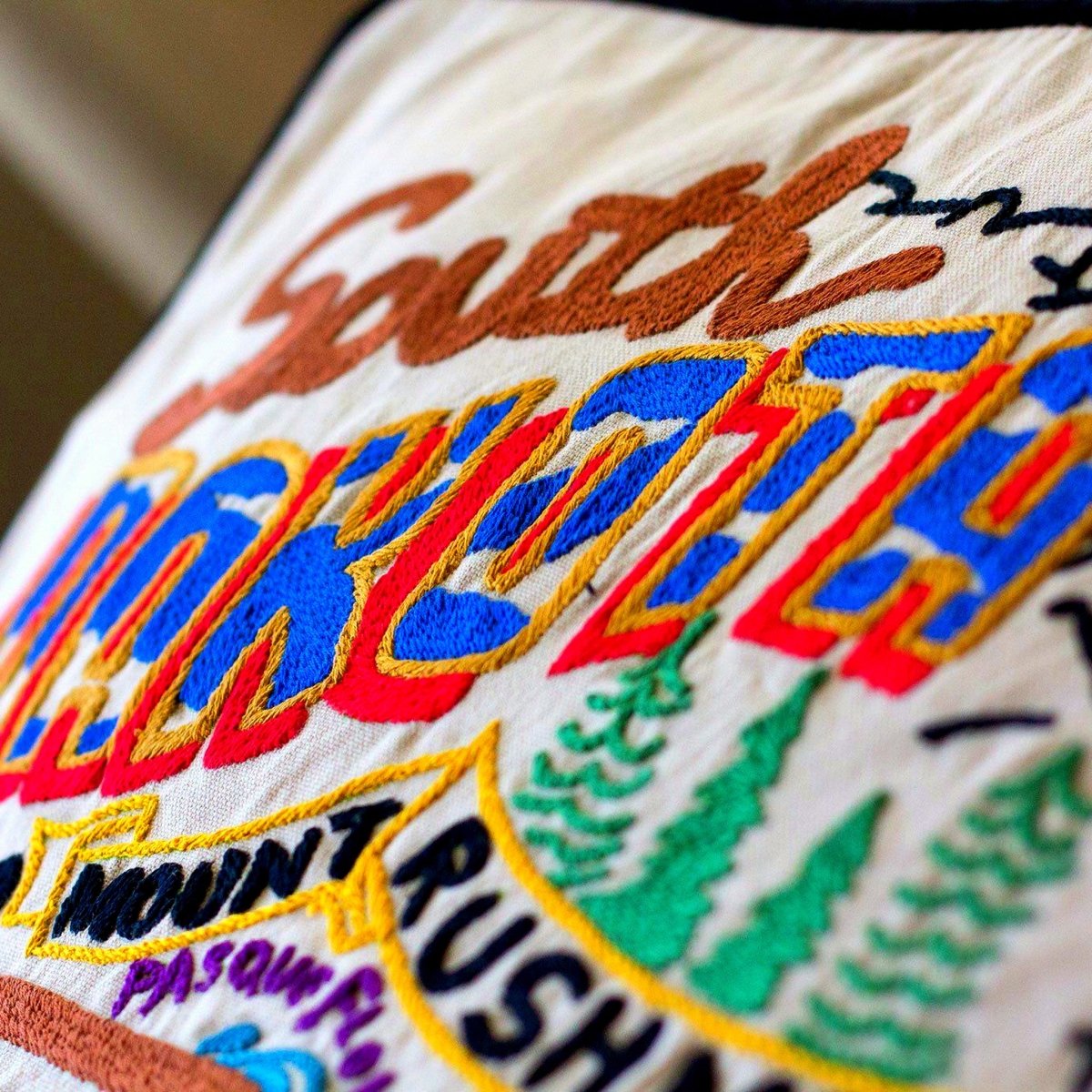 South Dakota State Rushmore Travel Embroidered Throw Pillow - close-up detail of hand-embroidered needlepoint stitching