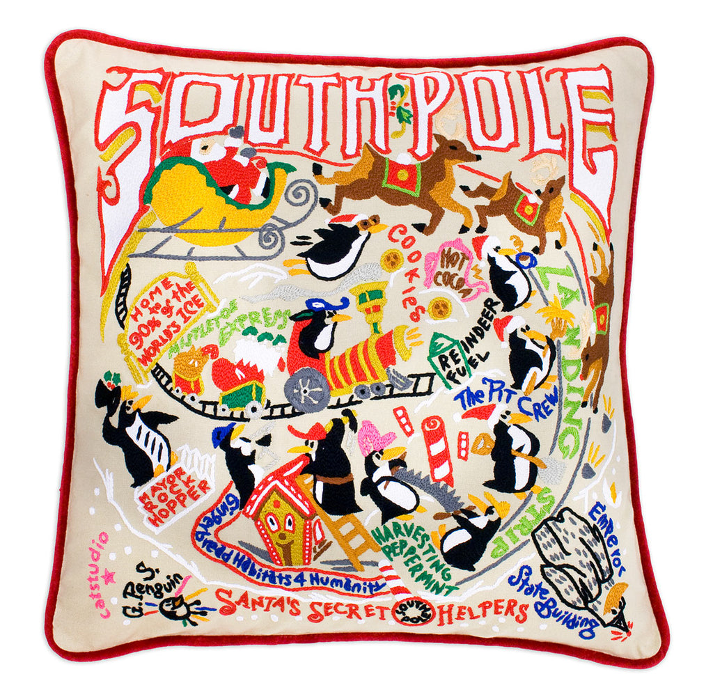 South Pole Holiday City embroidered throw pillow with festive winter scene.