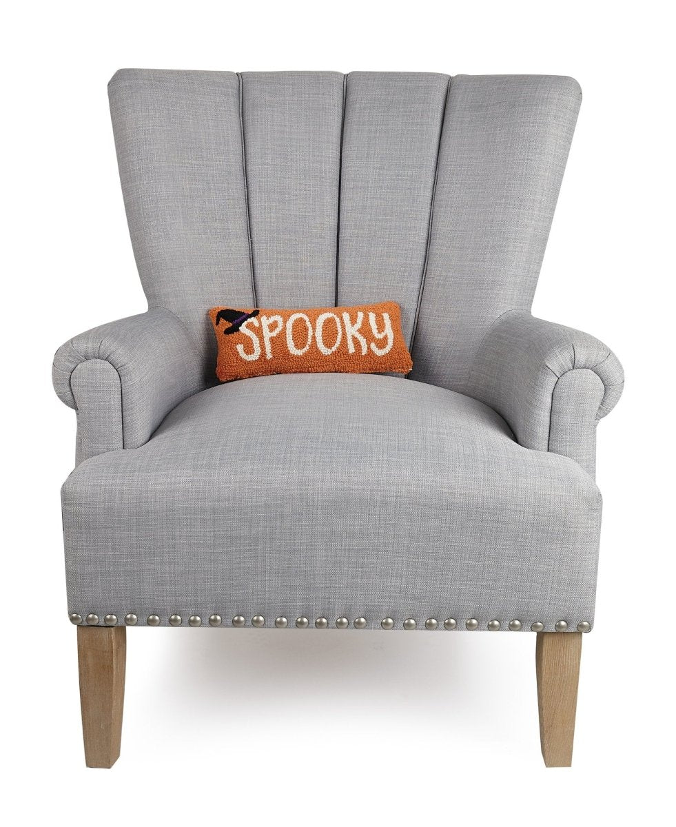 Spooky Hooked Wool Halloween Throw Pillow on an armchair, showing the throw pillow at room scale, 12x5 inch