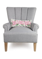Spotted Holiday Ho Ho Ho Hooked Wool Christmas Throw Pillow on an armchair, showing the throw pillow at room scale, 8x20 inch