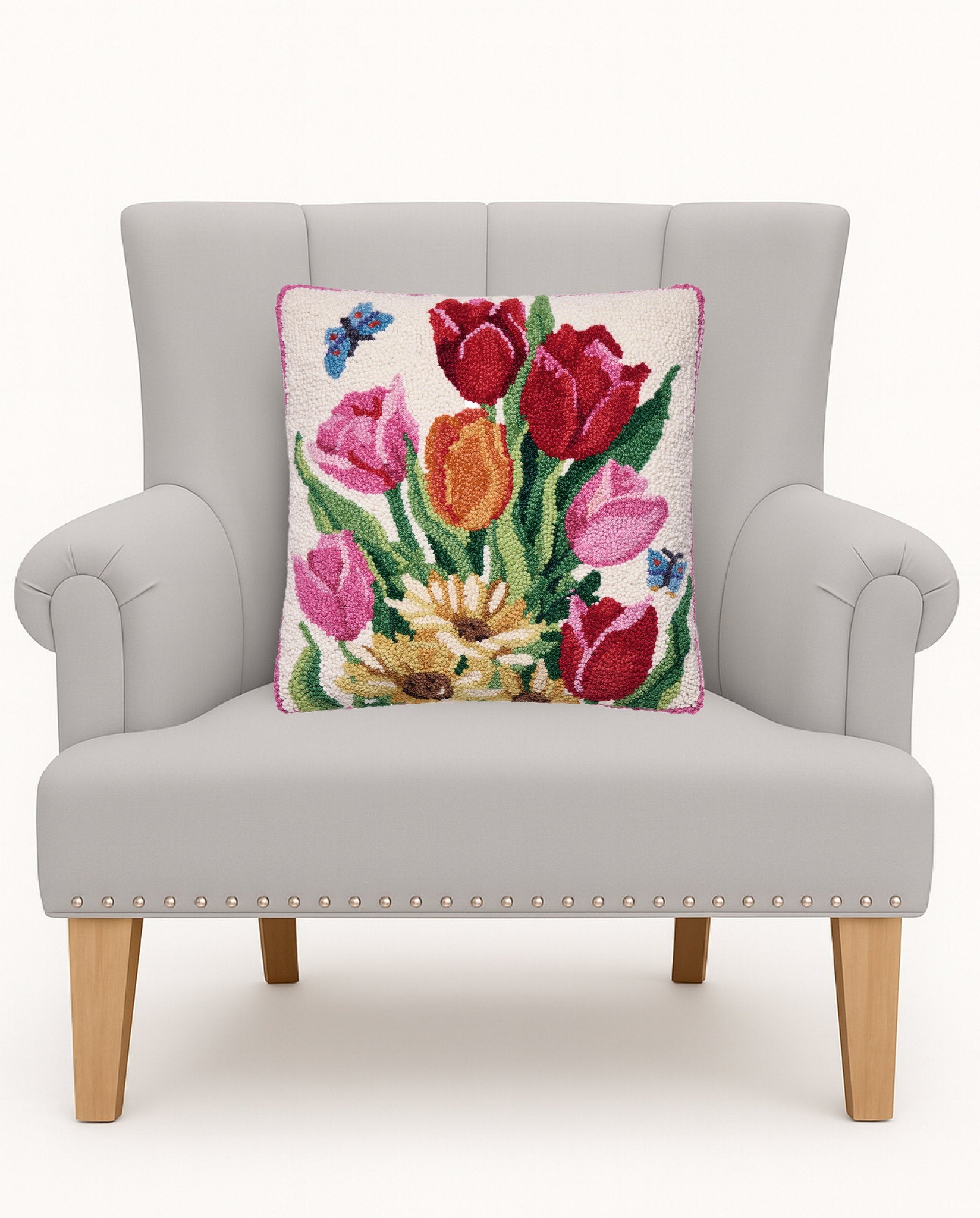 Springtime Tulips Hooked Wool Throw Pillow on an armchair, showing the throw pillow at room scale, 16x16 inch