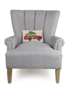 Station Wagon Tree Hooked Wool Christmas Throw Pillow on an armchair, showing the throw pillow at room scale, 8x12 inch