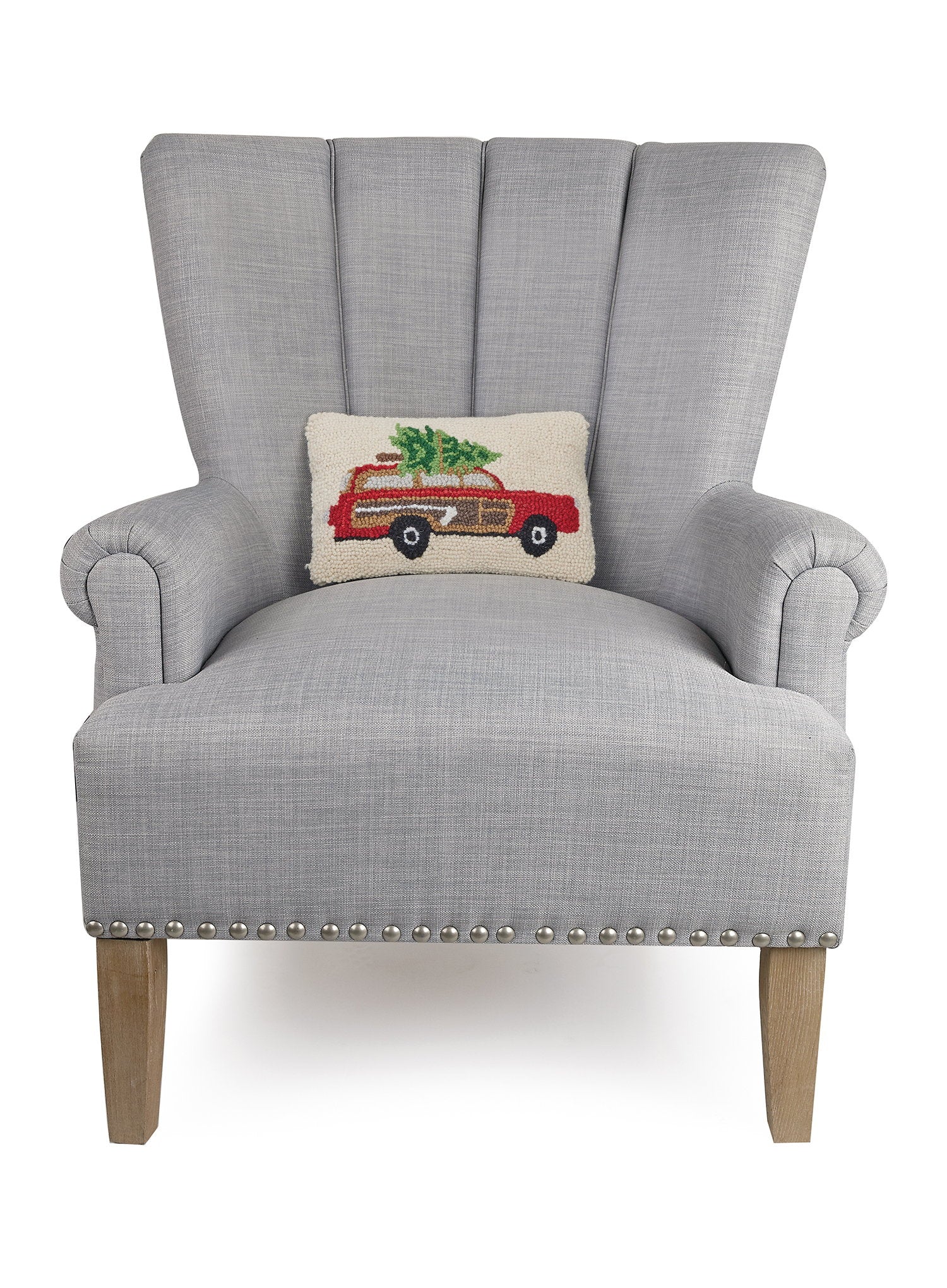 Station Wagon Tree Hooked Wool Christmas Throw Pillow on an armchair, showing the throw pillow at room scale, 8x12 inch