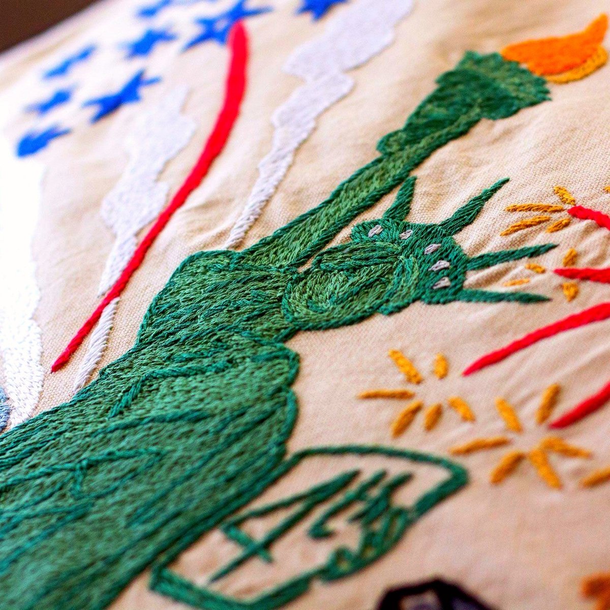 Statue of Liberty XL Embroidered Travel Throw Pillow - close-up detail of hand-embroidered needlepoint stitching